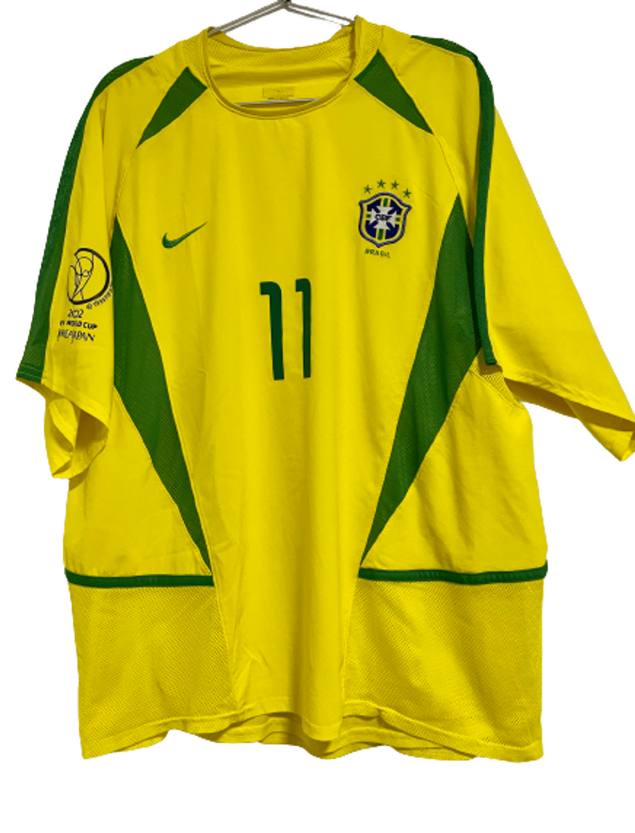 https://photos.enjoei.com.br/camisa-brasil-copa-2002-ronaldinho-11-duplo-tecido-original/1200xN/czM6Ly9waG90b3MuZW5qb2VpLmNvbS5ici9wcm9kdWN0cy8xMTYwNDk3NS84NDk1NTY5ZTdiY2VjMjZjZWVjNTI3MDAxZWYwMDk4NC5qcGc