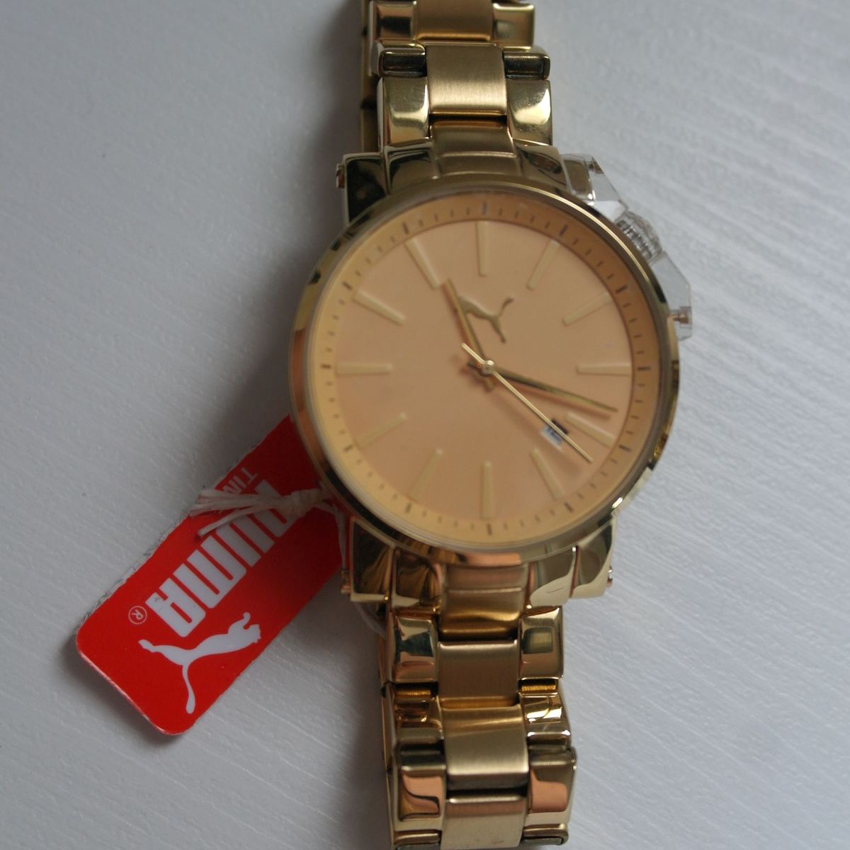 relogio da puma dourado