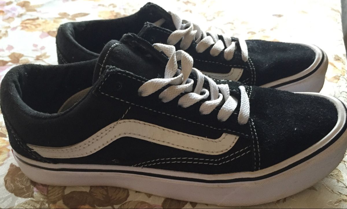 tenis preto com risco branco do lado