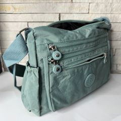 mochila transversal verde com forro e diversos bolsos
