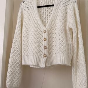 cardigan em trico vazado branco 150819285?action_source=75473&ref=home_home&rsp=1&rspix=1