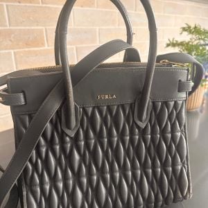 bolsa furla cinza media 146787946?action_source=67222&ref=home_home&rsp=1&rspix=1