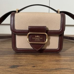 bolsa coach bege e marrom 150503641?action_source=76035&ref=home_home&rsp=1&rspix=1