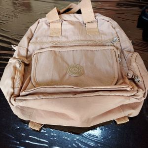 mochilinha nylon bege 134581636?action_source=67388&ref=home_home&rsp=1&rspix=1