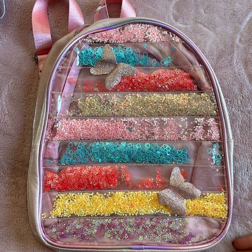 mochila plastico rosa com glitter infantil 132538952?action_source=66794&ref=home_home&rsp=1&rspix=1