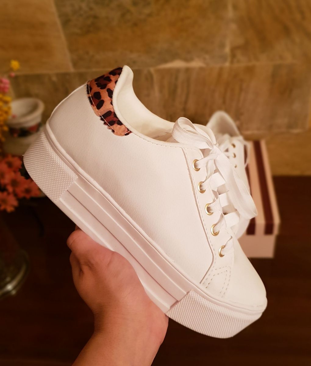 tenis branco com detalhe de onça