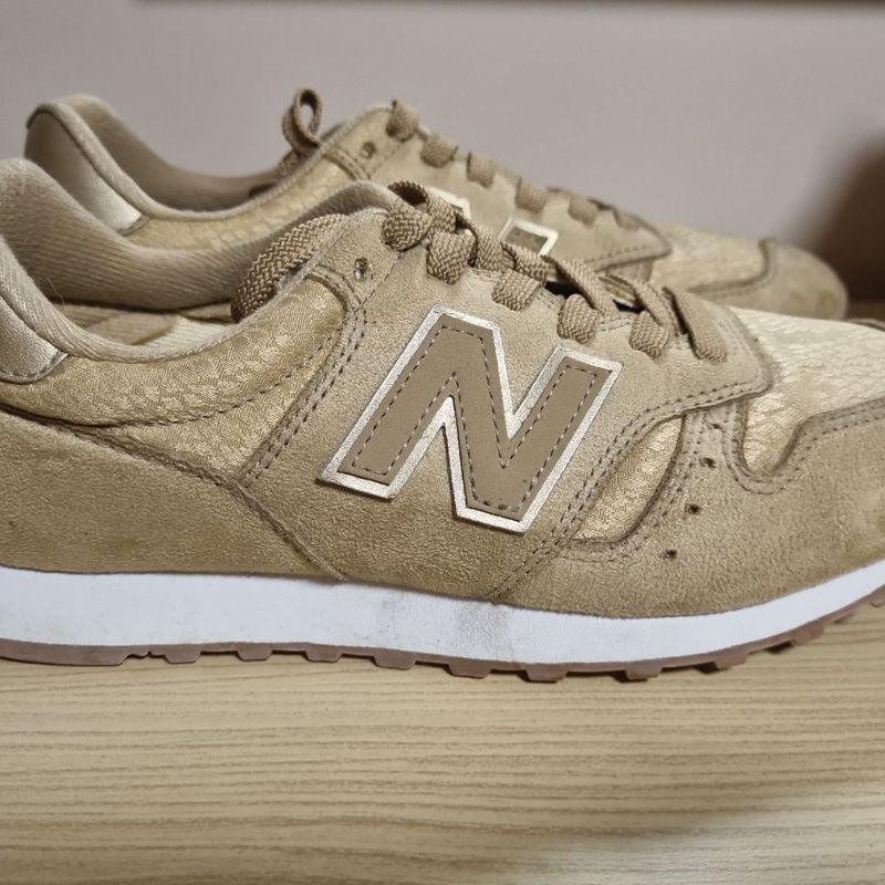 Tenis new balance dourado hot sale feminino